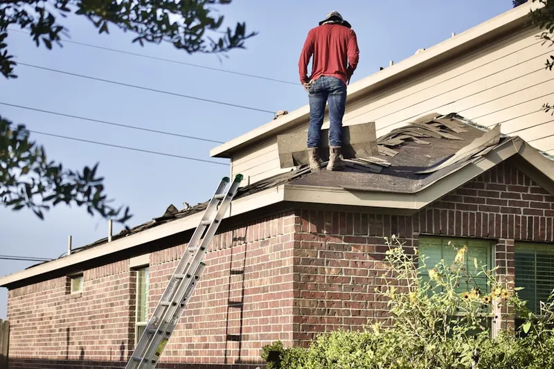 Professional roofer working on a residential roof in Centerbrook